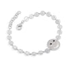 Silver bracelet with smiley face charm on a white background