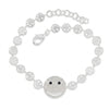 Silver bracelet with smiley face charm on a white background
