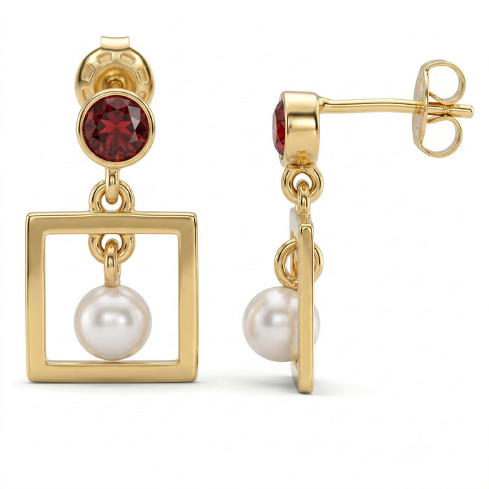 A pair of gold drop earrings featuring a round red gemstone, a square open-frame drop, and a white pearl dangling below, shown on a clean white background.