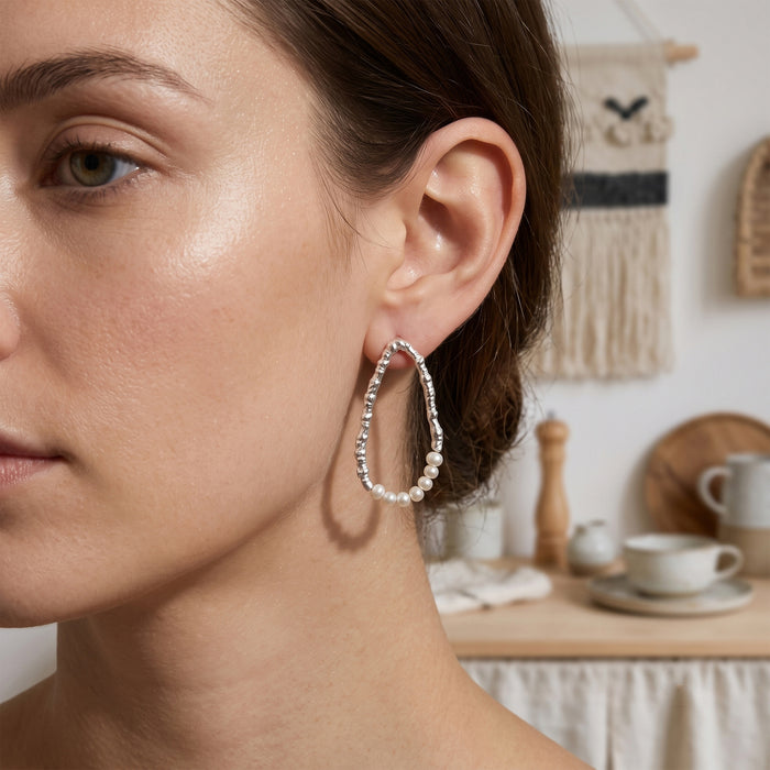 Freshwater pearl open hoop earrings in 18K gold plated and silver plated finish featuring fourteen round pearls and an organic open design