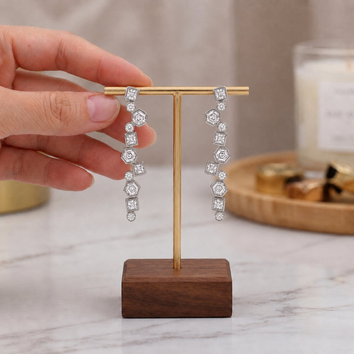Swarovski crystal geometric statement earrings in silver plated finish with hexagon, square, and round crystal accents.