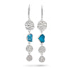 A pair of silver dangle earrings featuring textured silver discs, a small blue stone, and three smaller silver charms, shown on a white background.