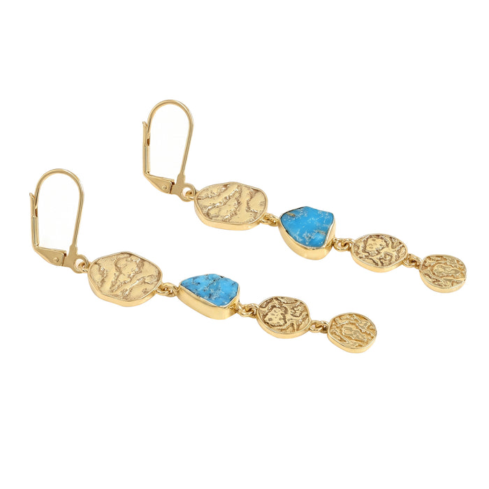Gold earrings with blue stone accents on a white background