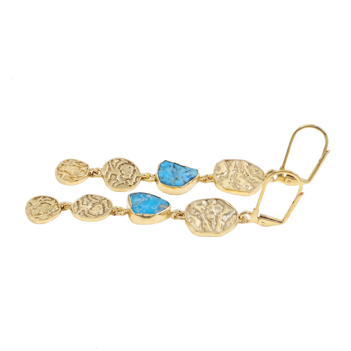 Gold earring with blue stones on a white background