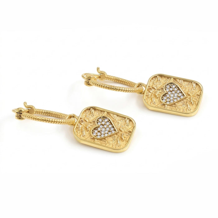 A pair of gold drop earrings featuring textured rectangular pendants with an openwork heart design and a central pave-set heart of clear stones, shown on a white background.