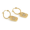 A pair of gold hoop earrings with textured rectangular dangles, decorated with a butterfly motif and small clear stones, shown on a plain white background.