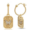 A pair of gold hoop earrings with textured rectangular dangles featuring a butterfly motif paved with small clear stones, shown on a white background.