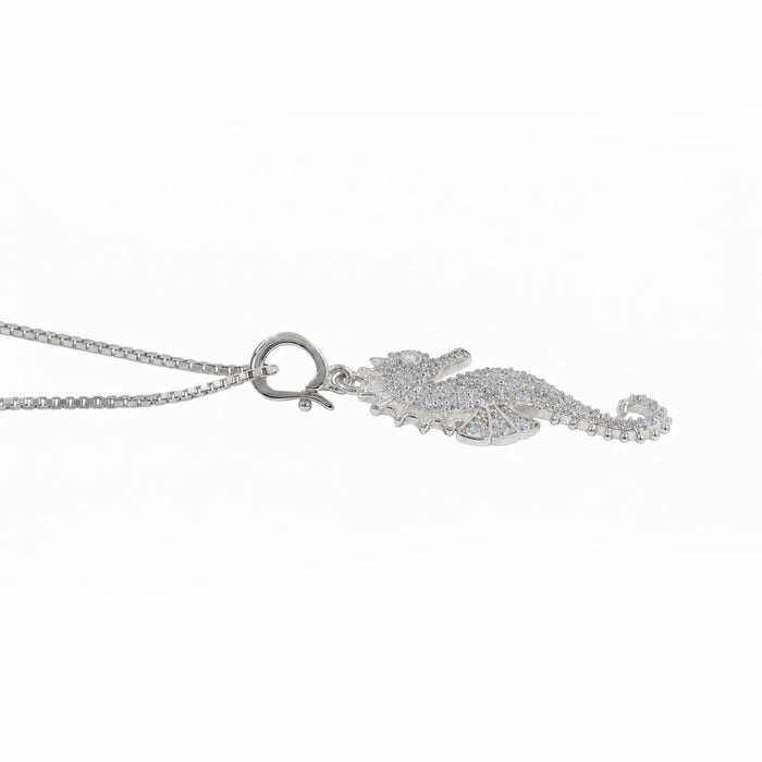 A silver-toned necklace featuring a seahorse-shaped pendant encrusted with small clear stones, shown on a plain white background.