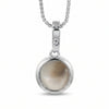 A silver pendant necklace featuring a round bezel-set Shiva Eye style stone with a soft beige and gray marbled pattern, suspended from a silver box chain against a white background.