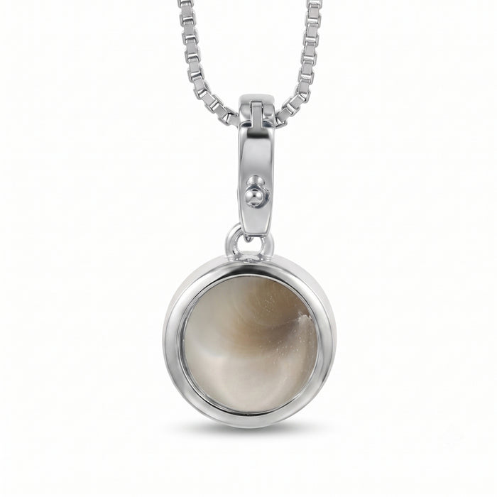 A silver pendant necklace featuring a round bezel-set Shiva Eye style stone with a soft beige and gray marbled pattern, suspended from a silver box chain against a white background.