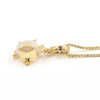 A gold fish pendant necklace featuring a large white pearl belly and a gold eye with tiny clear stones, suspended from a gold box chain on a white background.