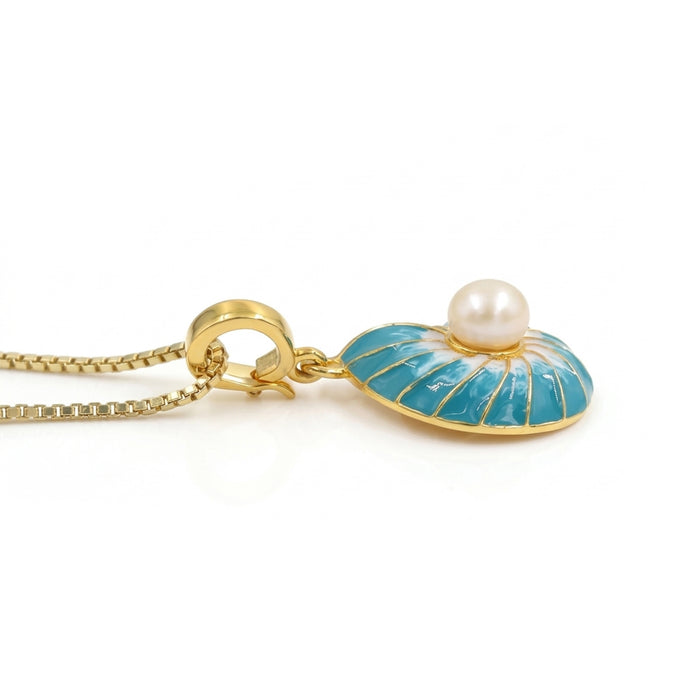 A gold pendant necklace featuring a nautilus shell-shaped enamel pendant topped with a single white pearl, suspended from a gold box chain on a white background.