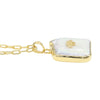 A gold chain necklace with a free size and fancy shape pendant featuring a white iridescent -biwa pearl background and a small gold animal in the center, shown on a plain white background.
