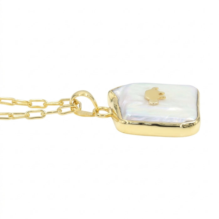A gold chain necklace with a free size and fancy shape pendant featuring a white iridescent -biwa pearl background and a small gold animal in the center, shown on a plain white background.
