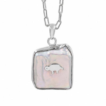 A silver chain necklace with a free size and fancy shape pendant featuring a white iridescent -biwa pearl background and a small gold animal in the center, shown on a plain white background.