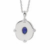 A silver pendant necklace featuring a scalloped circular design with a central oval blue lapis lazuli stone and small clear accent stones, shown on a white background.