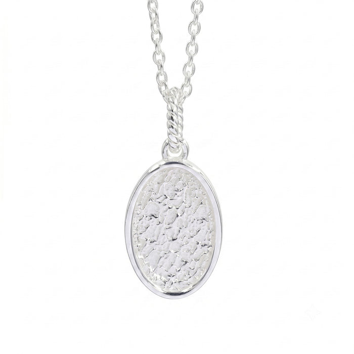 A silver oval pendant necklace with a textured, hammered finish inside a polished bezel setting, suspended from a delicate link chain against a plain white background.