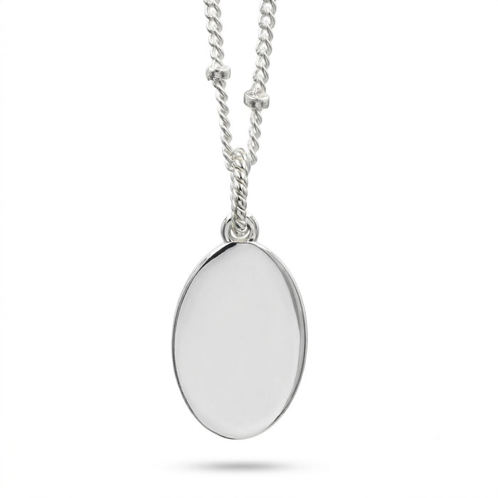 A silver oval pendant necklace with a polished, reflective surface, suspended from a silver chain on a clean white background.