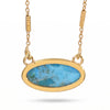 An oval pendant necklace featuring a vibrant turquoise-blue marbled stone in a polished gold bezel setting, suspended from a matching gold chain against a white background.