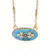 Gold oval pendant necklace featuring a turquoise-blue marbled stone center with a small round blue stone and five clear accent stones, suspended from a gold chain on a white background.