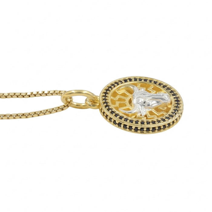 Black onyx Taurus bull pendant necklace in 1 micron 18K gold plated finish, suspended from a gold box chain against a white background.