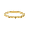A yellow gold beaded band ring with a polished finish, set against a plain white background.