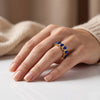 Close-up view of lapis lazuli pear-cut eternity ring showing prong settings and natural pyrite inclusions