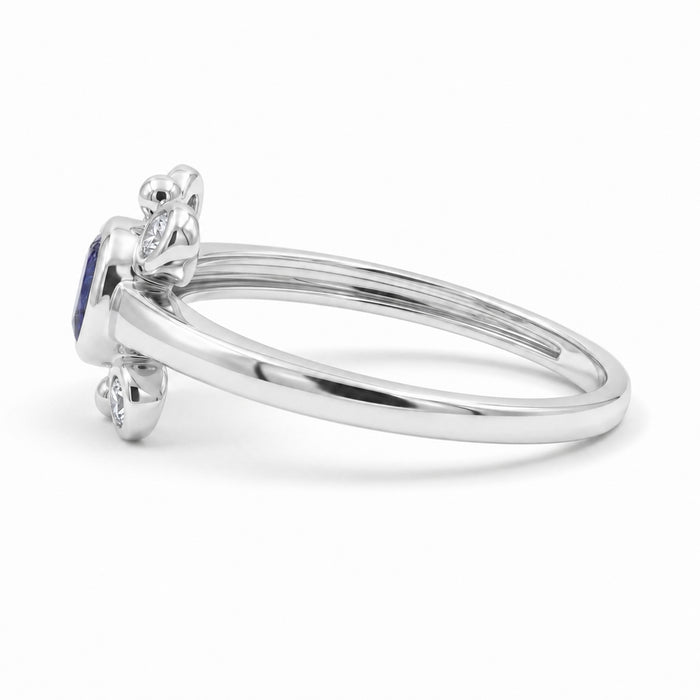 
Natural tanzanite and Swarovski crystal bezel ring in 18K gold plated and silver plated finishes with round gemstones.