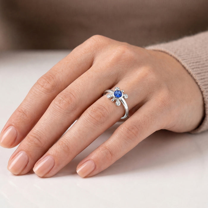 
Natural tanzanite and Swarovski crystal bezel ring in 18K gold plated and silver plated finishes with round gemstones.
