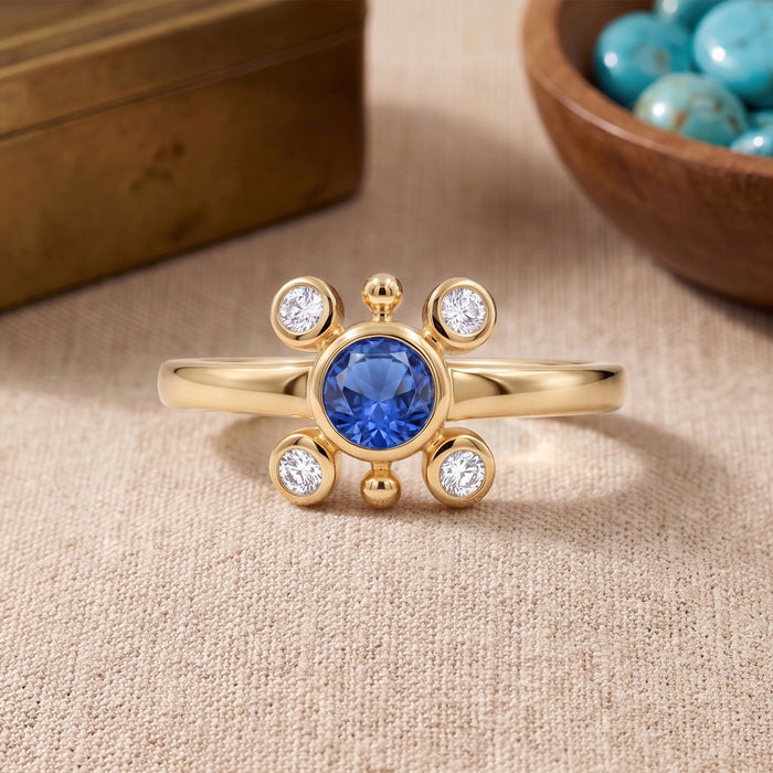 
Natural tanzanite and Swarovski crystal bezel ring in 18K gold plated and silver plated finishes with round gemstones.