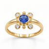 
Natural tanzanite and Swarovski crystal bezel ring in 18K gold plated and silver plated finishes with round gemstones.