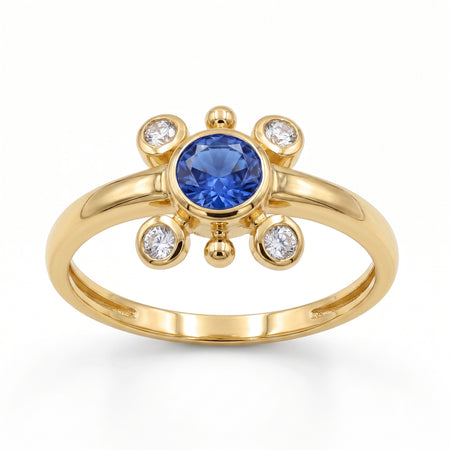 
Natural tanzanite and Swarovski crystal bezel ring in 18K gold plated and silver plated finishes with round gemstones.