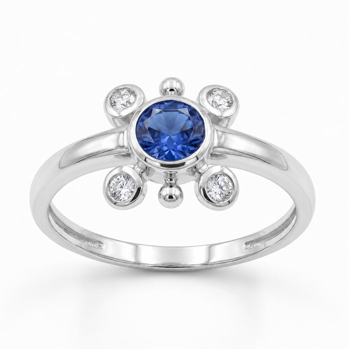 A silver ring featuring a round-cut tanzanite center stone and four small clear accent stones, shown on a clean white background.