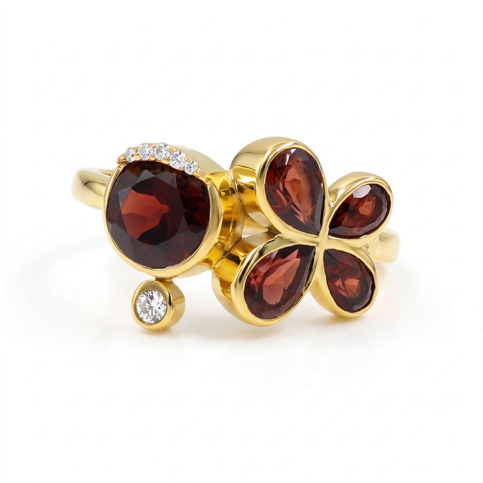 Natural garnet floral bypass ring with pear-cut garnet gemstones and Swarovski crystal accents in 18K gold & silver plated finish on a white background.