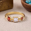Natural garnet and Swarovski crystal ring in 18K gold plated and silver plated finishes featuring oval, round, and square bezel-set gemstones