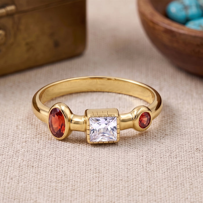 Natural garnet and Swarovski crystal ring in 18K gold plated and silver plated finishes featuring oval, round, and square bezel-set gemstones