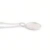 A silver oval pendant necklace with a textured, hammered finish inside a polished bezel setting, suspended from a delicate link chain against a plain white background.