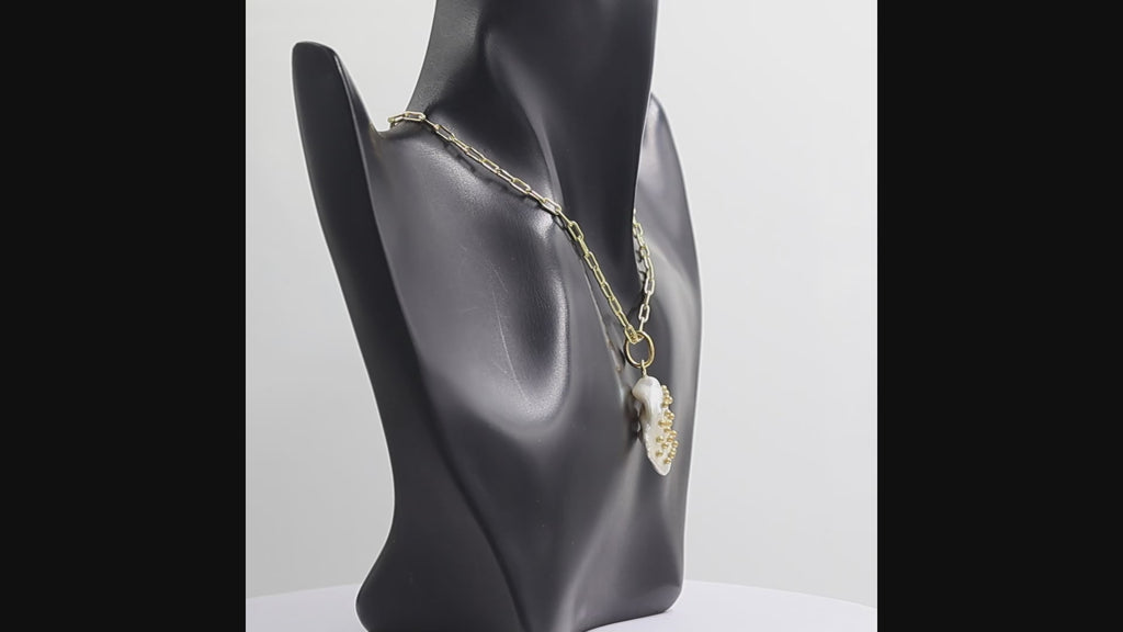 Gold paperclip chain necklace with a single free-size baroque freshwater pearl pendant featuring metal stud accents