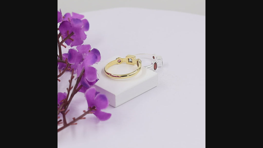 Natural garnet and Swarovski crystal ring in 18K gold plated and silver plated finishes featuring oval, round, and square bezel-set gemstones