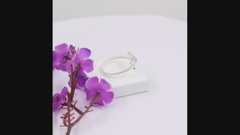 
Natural tanzanite and Swarovski crystal bezel ring in 18K gold plated and silver plated finishes with round gemstones.