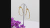 Freshwater pearl open hoop earrings in 18K gold plated and silver plated finish featuring fourteen round pearls and an organic open design
