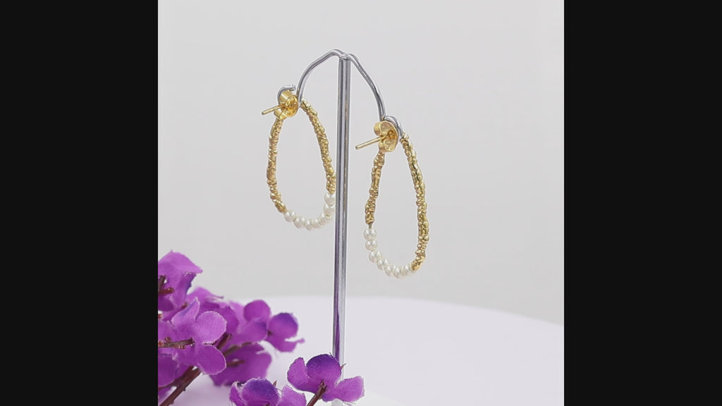 Freshwater pearl open hoop earrings in 18K gold plated and silver plated finish featuring fourteen round pearls and an organic open design