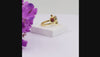 Natural garnet floral bypass ring with pear-cut garnet gemstones and Swarovski crystal accents in 18K gold & silver plated finish on a white background.