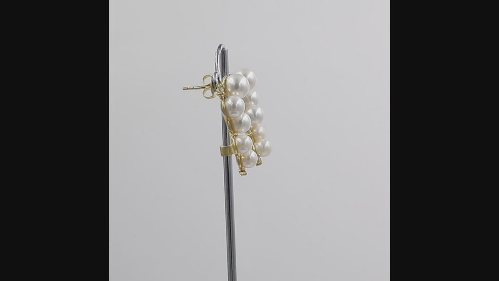 360-degree video of a cluster of five white pearl ear climber earrings in a curved, ear cuff-style arrangement shown on a white background.